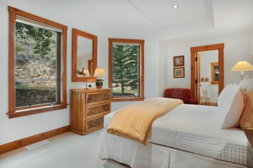 a bedroom with a bed and two windows at 358 Cresta Road in Edwards