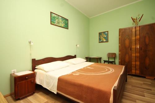 a bedroom with a large bed and a wooden cabinet at Family friendly seaside apartments Susak, Losinj - 8050 in Susak