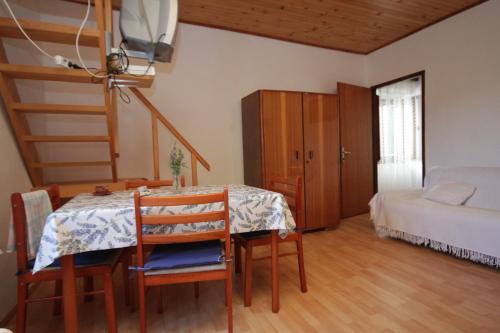 a room with a table and chairs and a bed at Apartments with a parking space Veli Losinj, Losinj - 8060 in Veli Lošinj