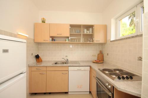 a kitchen with a sink and a counter top at Apartments with a parking space Opatija - Pobri, Opatija - 7918 in Volosko