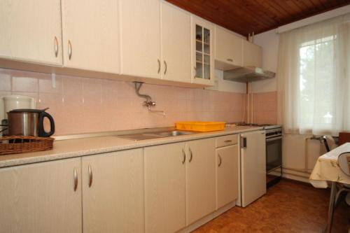 a kitchen with white cabinets and a sink at Apartments and rooms by the sea Mali Losinj (Losinj) - 7953 in Mali Lošinj