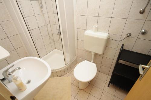 a bathroom with a toilet and a sink and a shower at Studio Mali Losinj 7953a in Mali Lošinj