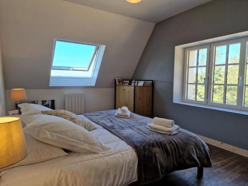 a bedroom with a bed with two towels on it at House in Plougasnou near Stunning Beaches in Plougasnou
