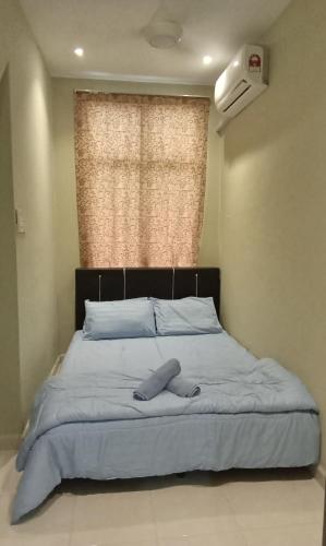 a bed in a bedroom with a large window at NZ Villa Roomstay in Kangar