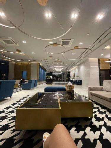 a lobby with a couch and a table and chairs at Minimalist Cozy Condo Studio Unit in Grand Residences Cebu in Cebu City