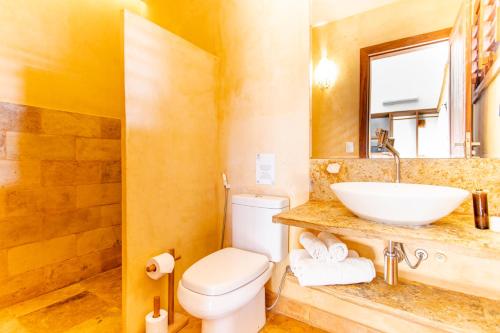 a bathroom with a sink and a toilet at CasaLô Hotel in Jericoacoara