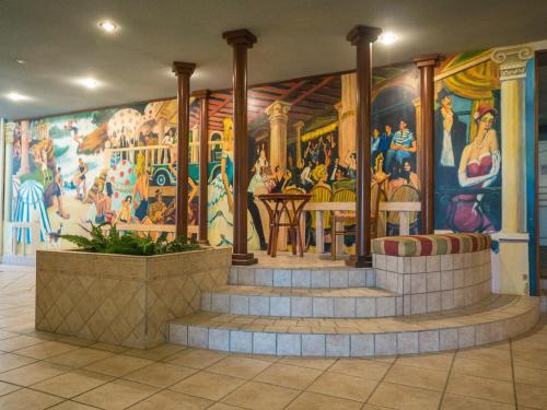 a mural on the wall of a room with stairs at Résidence Mer & Golf Eugénie in Biarritz