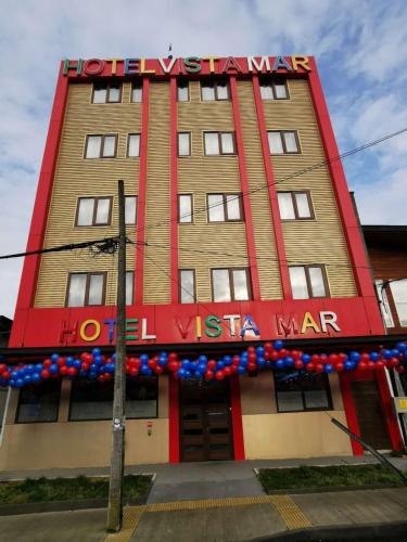 a hotel with a sign on the front of a building at Hotel Vista Mar in Puerto Montt