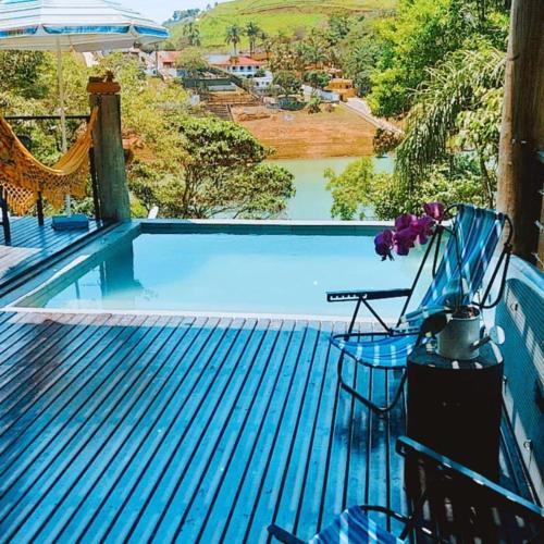 a swimming pool on the deck of a house at Igarata Cabana da Sol in Igaratá