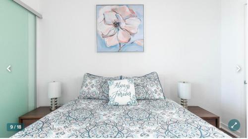 a bedroom with a bed with a flower picture on the wall at Million dollar lake view - 2 bedroom Cando across the lake with stunning lake view in Toronto