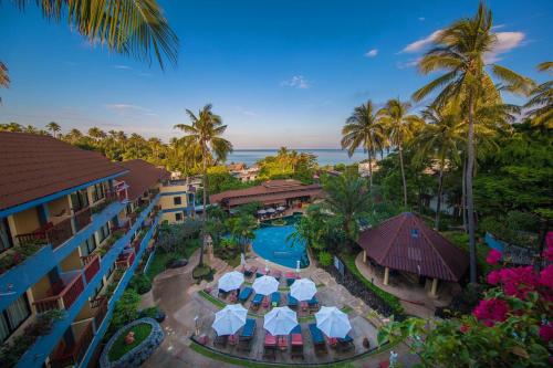 an aerial view of a resort with a pool and palm trees at Karona Resort & Spa - SHA Extra Plus in Karon Beach