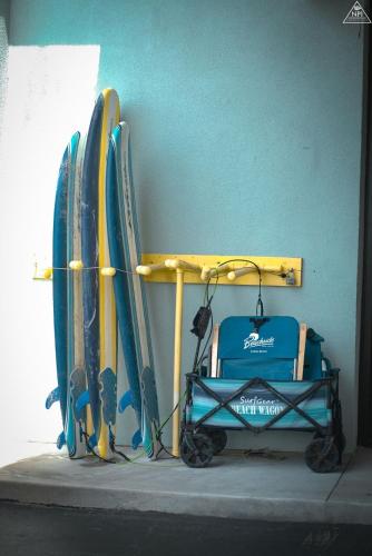 a room with surfboards leaning against a wall with a stroller at Beachside Hotel & Suites Cocoa Beach - Port Canaveral in Cocoa Beach