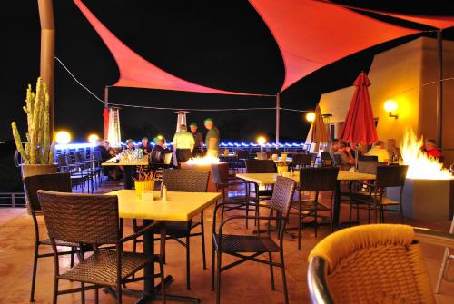 a restaurant with tables and chairs and people at night at Gold Canyon Golf Resort in Gold Canyon