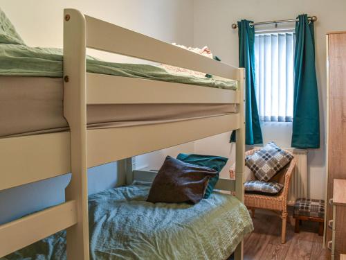 a bedroom with two bunk beds in a room at Britannic Chambers Apartment in Blaenau-Ffestiniog