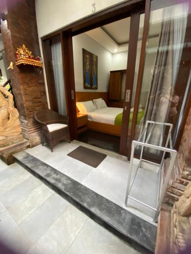 a bedroom with a bed and a ladder in a room at Rahayu Guest House Seminyak in Seminyak