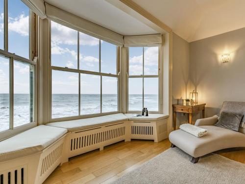 a window seat in a room with a view of the ocean at The Bath House in Cromer