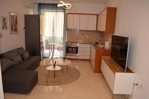 a living room with a couch and a table at Anastasias apartment tripoli in Tripolis