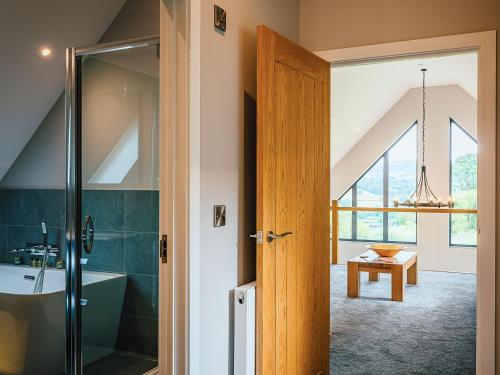 a bathroom with a shower and a glass door at Coed Y Pentre in Carno