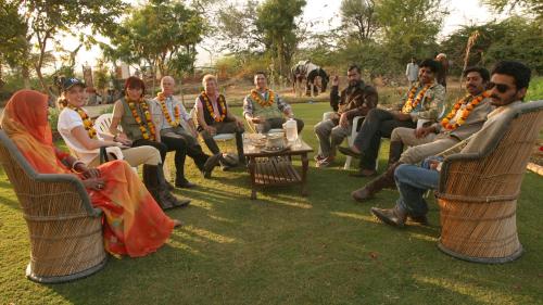 a group of people sitting in chairs in the grass at Korta Escape- A Heritage Resort in Jawai in Korta