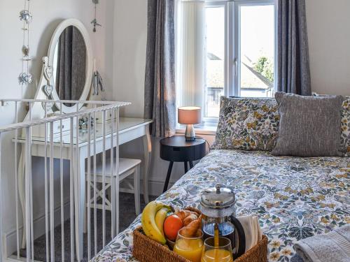 a room with a bed with a tray of fruit on it at La Casita in Herne Bay