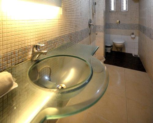 a bathroom with a sink and a toilet at Hotel Lee International in Kolkata