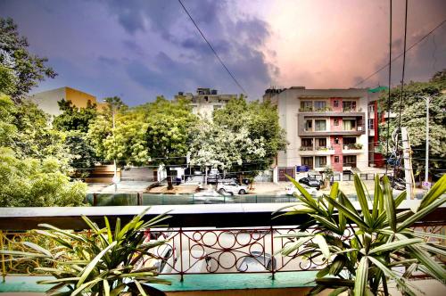 a view of a city from a balcony with plants at Lime Stays B&B GK-2 at Greater Kailash Metro South Delhi nearby Saket Select City in New Delhi