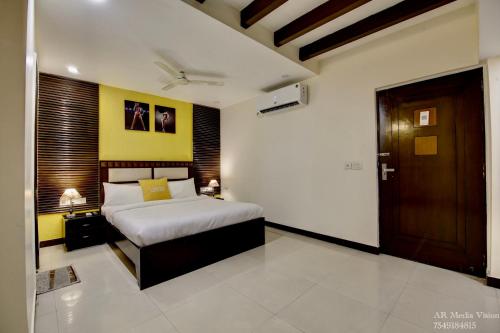 a bedroom with a bed and a wooden door at Lime Stays B&B GK-2 at Greater Kailash Metro South Delhi nearby Saket Select City in New Delhi