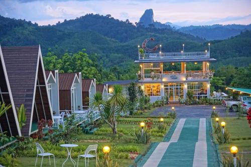 a view of a house with a mountain in the background at 99 Camp and Cafe in Khao Sok National Park