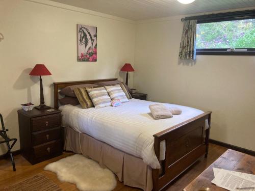 a bedroom with a large bed and a window at Avoca Park Equestrian Farmstay in Macclesfield