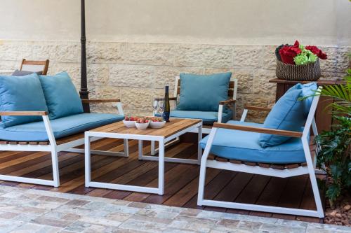 two chairs and a table on a patio at Carmel Pearl in Haifa