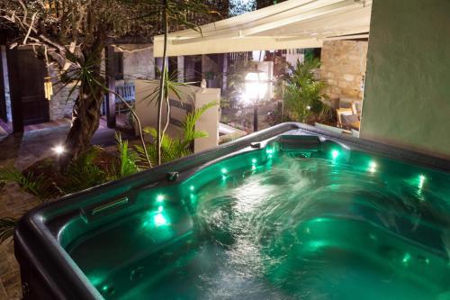 a jacuzzi tub in a backyard at night at Carmel Pearl in Haifa