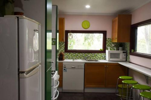 a kitchen with a refrigerator and a sink at Avoca Park in Macclesfield