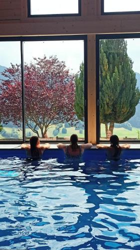 a group of people in a swimming pool at Chalet Titlis in Bernex