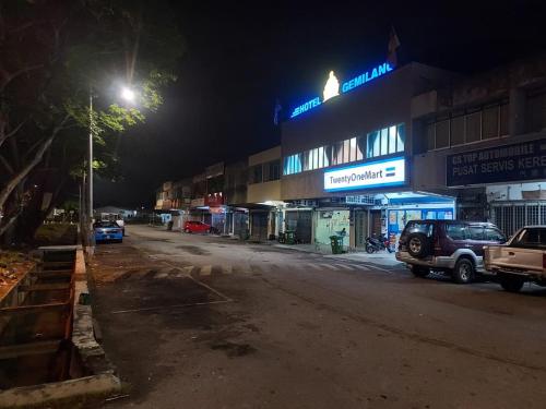 a parking lot in front of a building at night at Gemilang Hotel Klang in Teluk Panglima Garang