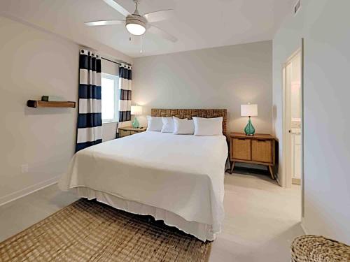 a bedroom with a large white bed and a window at Sea Glass #201 in Gulf Shores