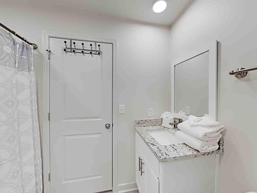 a white bathroom with a sink and a shower at Sea Glass #201 in Gulf Shores