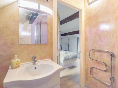 a bathroom with a sink and a mirror and a bed at Shibden Suite - Uk38332 in Halifax