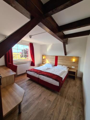 a bedroom with a large bed and a window at Hotel Elb Blick in Jork