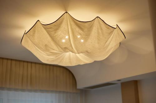 a light fixture hanging from the ceiling at Hotel Saraceno Resort with Private Beach in Milano Marittima