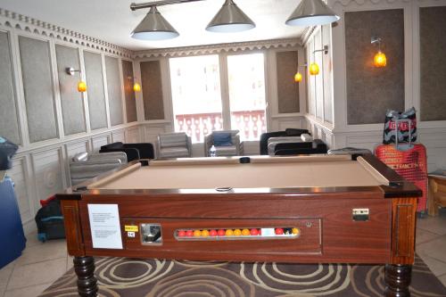 a pool table in the middle of a room at Résidence Montana Premier in Val Thorens