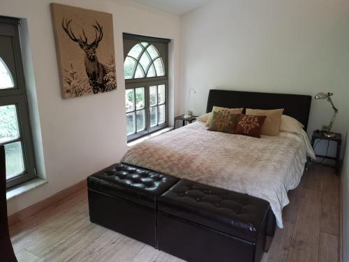 a bedroom with a bed and a couch in it at Eremyten Hof in Evergem