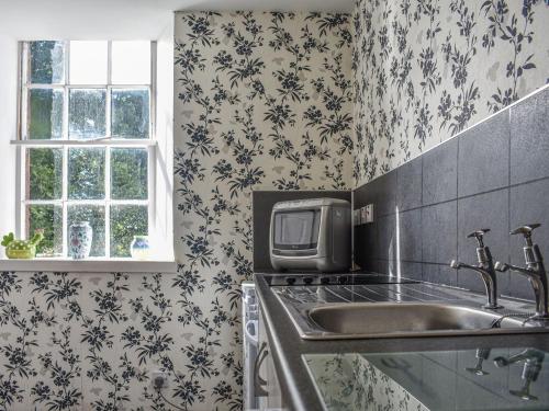 a kitchen with a sink and a microwave at Hayfield - Uk35890 in Turriff