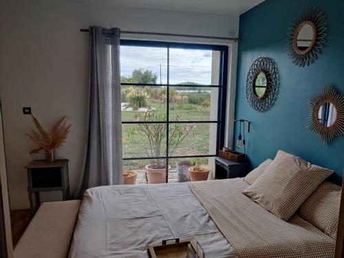 a bedroom with a bed and a large window at Ravissante Suite 90m2 près des bord de Loire in Saint-Julien-de-Concelles