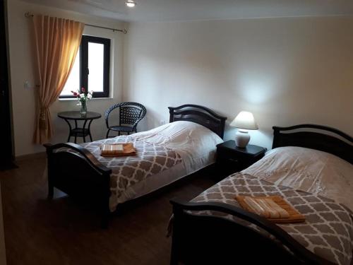 a bedroom with two beds and a window at Villa Mimi in Bazmakhpyur