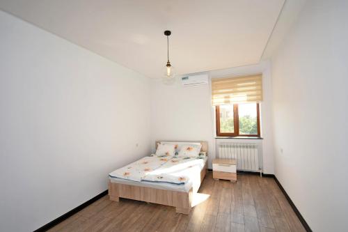 a white room with a bed and a window at Villa in Nork in Yerevan
