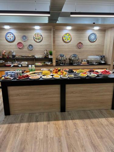 al Madina Hotel Samarkand في سمرقند: بوفيه مع العديد من أطباق الطعام على منضدة