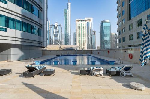 a swimming pool in a city with buildings at Dubai Marina - Stunning Huge 4 Bedroom Apts Near JBR - Gym - Pool - Parking by Sojo Stay in Dubai