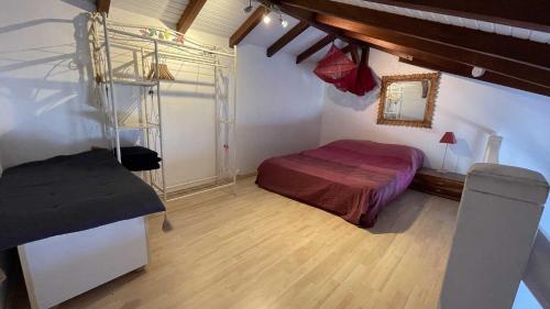 a bedroom with a bed and a ladder in a room at Appartement La Cannelle in Les Trois-Îlets