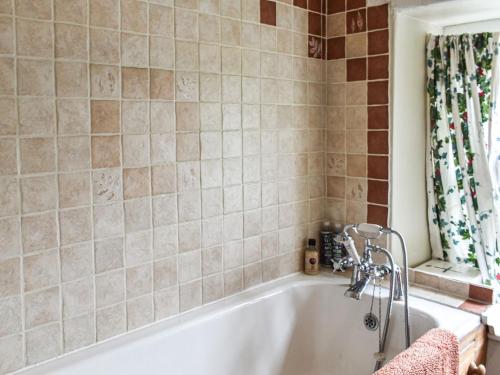 a white bath tub in a bathroom with a window at Nant Y Crogwyn in Penmachno