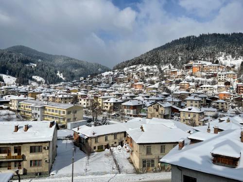 a small town covered in snow with houses at ORION APARTMENTS in Chepelare